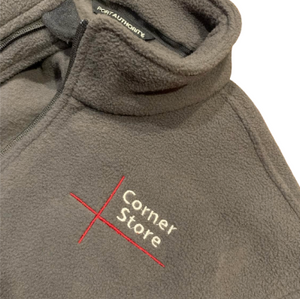 Grey fleece jacket with 'Corner Store' logo on a white background
